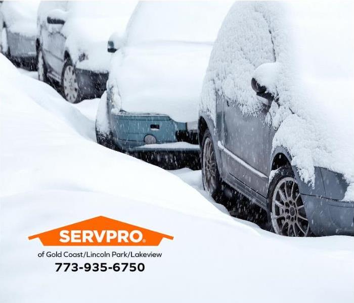 Deep snow covers cars in a residential area of Chicago.  