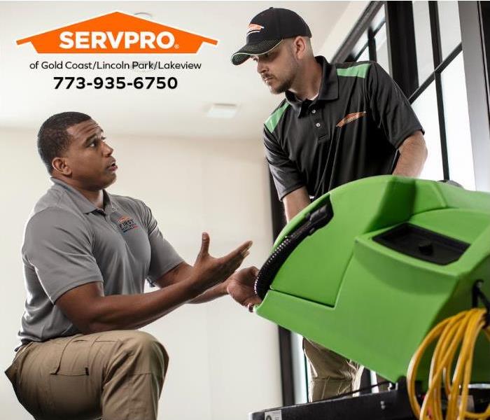 A SERVPRO technician discussing a water restoration job with his manager.