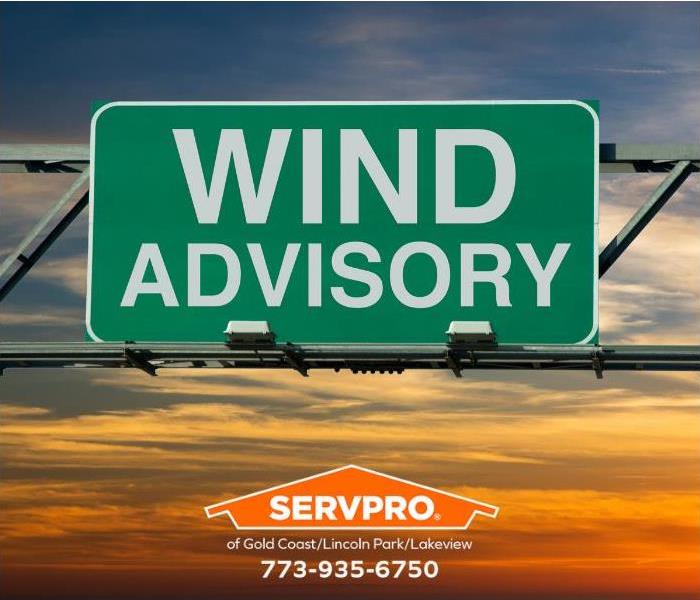 A wind advisory sign is shown.