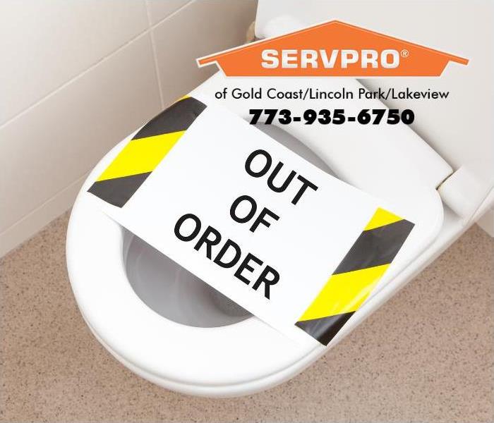 An “out of order” sign is posted on a toilet.   