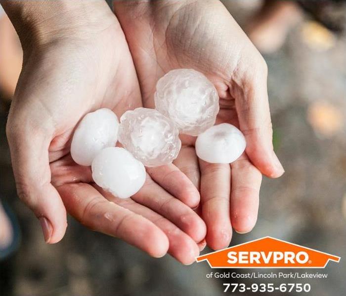 A person is holding some hailstones.